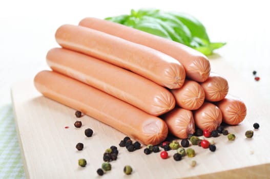 Sausages arranged on a board over white background