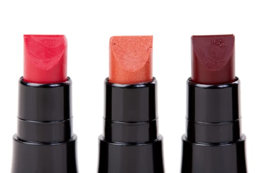 Three lipstick set in a row, isolated on white background