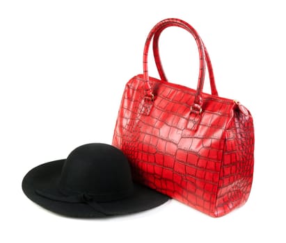 Red Fashion ladies handbag and a black felt hat in the studio on a white background