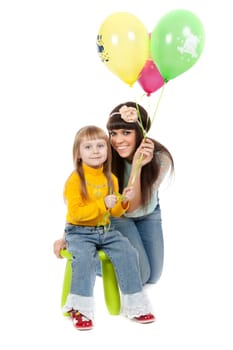 Mother and his daughters with colorful balloons. studio shoot over white background