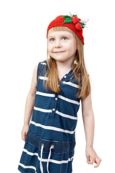 pretty little girl in beautiful striped blue dress and a red cap with a pattern of strawberries isolated on white background
