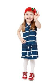 Little beautiful girl threatens her finger in the red cap with a pattern of strawberries. Isolate on white