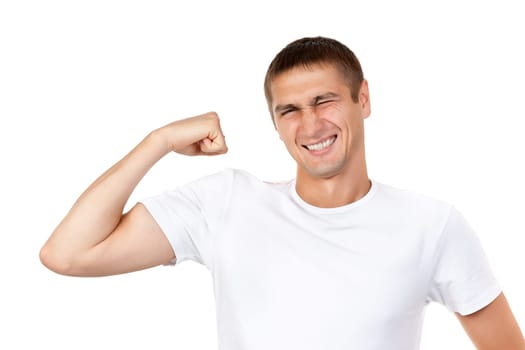 Portrait of young handsome dark-haired man wearing white t-shirt, holding his arm up to show how strong he, isolate white background