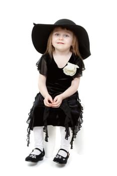 A little sweet girl a black hat with wide brim.