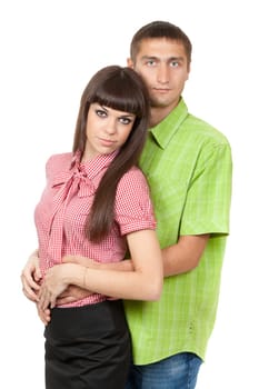 Young couple in a plaid colored clothes hug on white in studio.