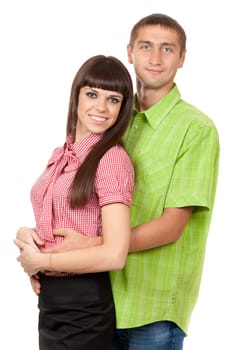 A man in a green plaid shirt hugs a beautiful brunette girl in a red plaid shirt. Family portrait on a white background.