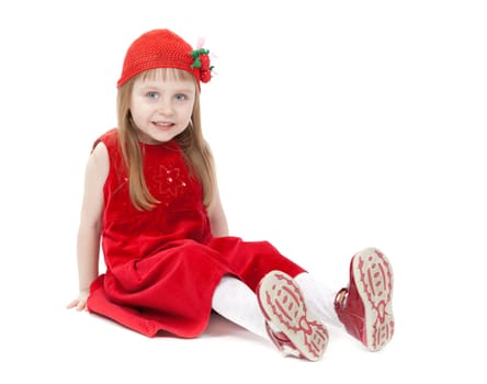 Cute little girl in a red dress sitting on the floor. Isolate on white.