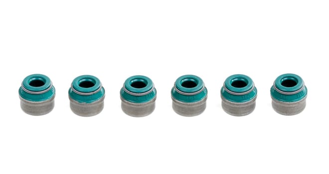 six original green valve stem seals isolated on white background