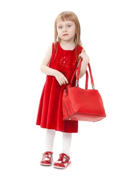 Little girl portrait holding an red handbag on her shoulder