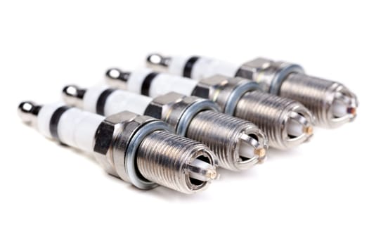 Set four spark plugs. Isolated on white.