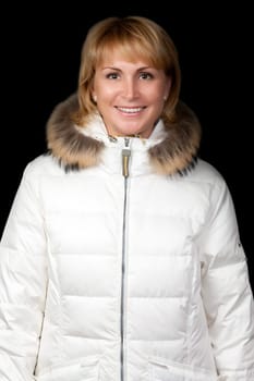 portrait of a beautiful girl in a winter jacket on a black background