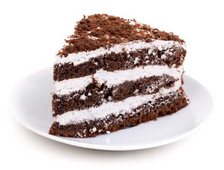 Slice of chocolate cake stuffed with whipped cream and white chocolate on white background