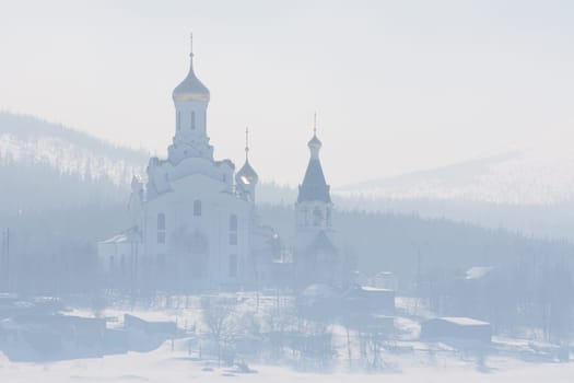 The Orthodox church with golden domes in the fog