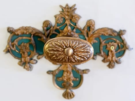 Antique golden door handle on the bright background