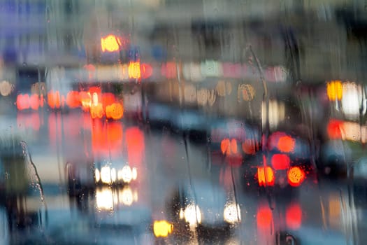 lights of the city at night through a wet glass.