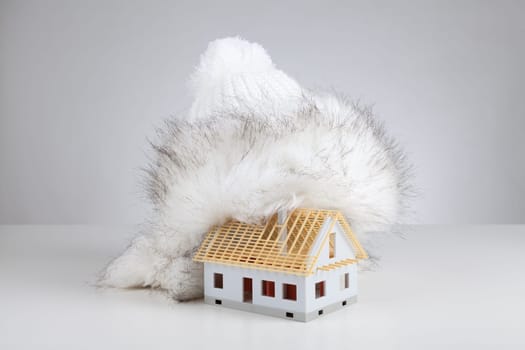 Cap isolate model of rough construction house against heat leak - unfinished house insulation concept. Prepare rough construction for winter concept.