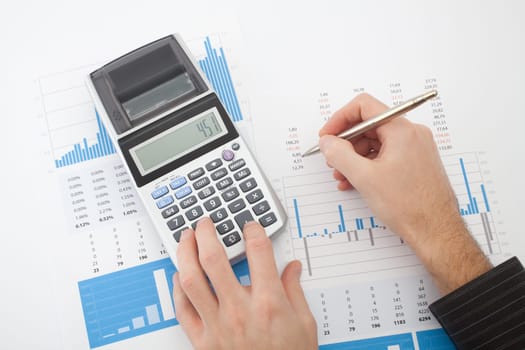 Business analysis - calculator, sheet, graphs (business report) and analyst hand, top view