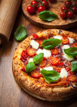 Pizza with salami, mozzarella and basil