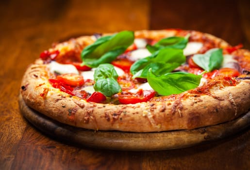 Pizza with salami, mozzarella and basil