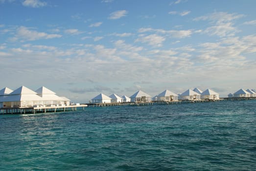 Delicate Clouds Over the Maldives Water Bungalow