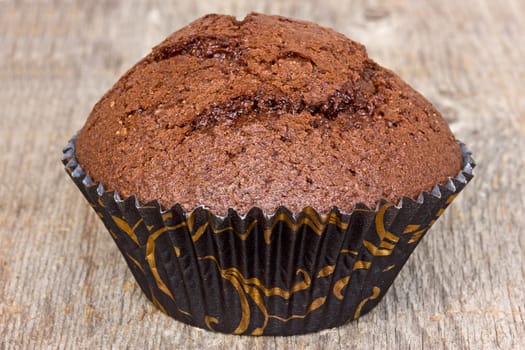 Chocolate muffin on the old  wooden plank
