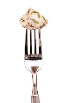 Roasted monkfish with pepper and rosemary on a fork