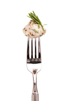 Monkfish with rosemary on a fork against a white background