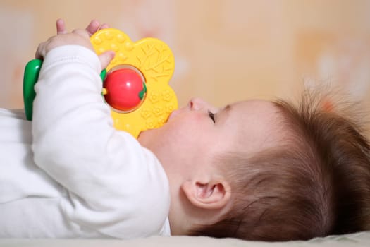 Portrait of a playing baby lying down on back