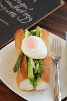 Delicious asparagus and mashed peas topped with a poached egg on a crispy baguette.