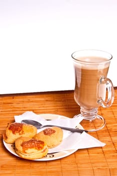 shortbread cookies with apples and coffee for breakfast standing on a bamboo mat and white background