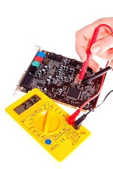electronics engineer testing computer part in electronics workshop