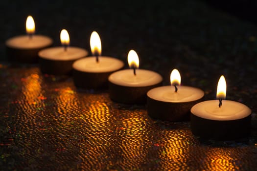 Burning candles on dark background
