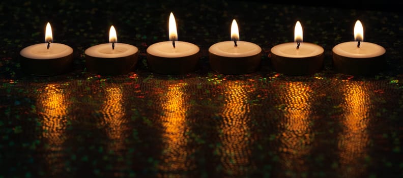 Burning candles on dark background