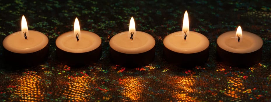 Burning candles on dark background
