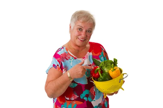 Senior woman with fresh vegetables - isolated on white background