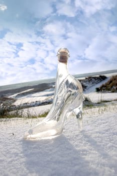 a crystal glass slipper in a snow covered irish golf course for a concept on ladies golf