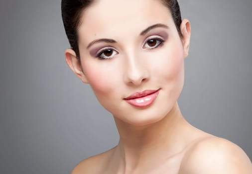 Studio portrait of a beautiful young woman smiling