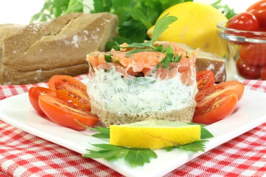 a slice of bread with herb cream and salmon tartare