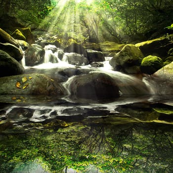 Cascade falls over old plum river with rocks