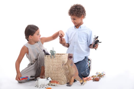 Brother and sister playing with toy animals