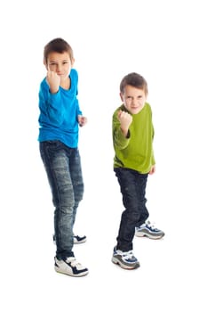 Two boys in a fighting stance. Studio shot.