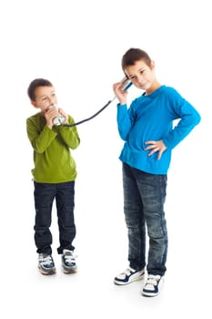 Two boys calling tin can phone. Studio shot.