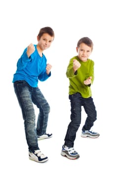 Two boys in a fighting stance. Studio shot.