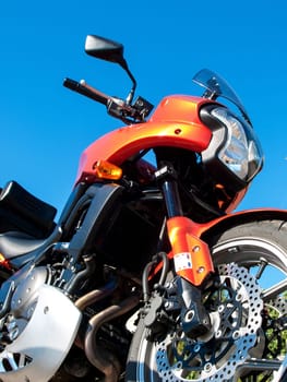 orange motorbike and a blue sky