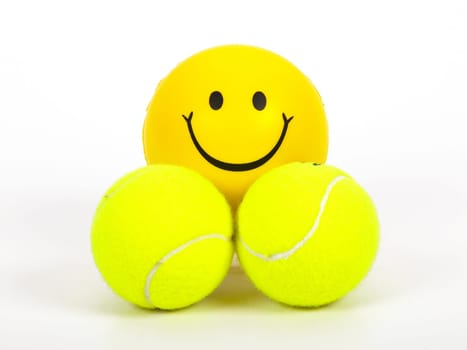 smiling tennis ball and two normal balls