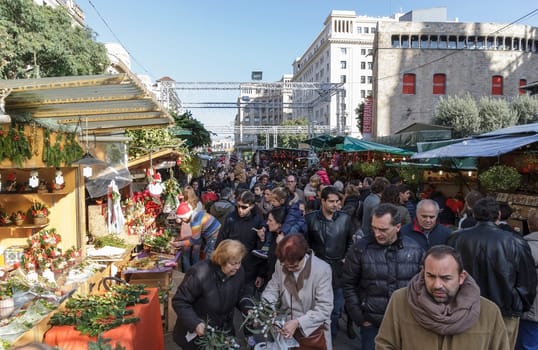 BARCELONA, SPAIN - DECEMBER 08: Unidentified people visits the famous Santa Llucia Festival to buy Christmas decoration, as pines trees and crib figures, on December 08, 2012, in Barcelona, Spain.