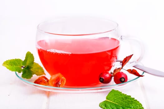 fresh red tea from rose hips against white background