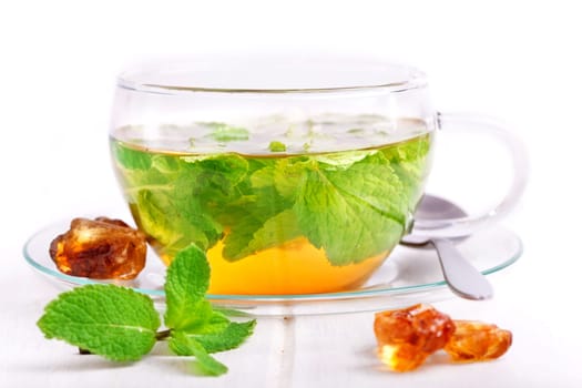 a cup of fresh mint tea against a white background