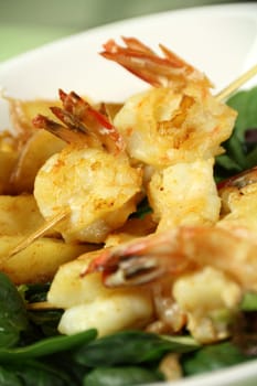 Yummy fried shrimp skewers with chunky chips ready to serve.
