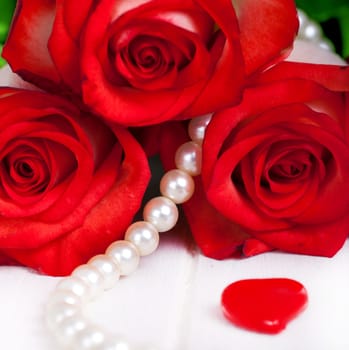 red roses with pearl necklace